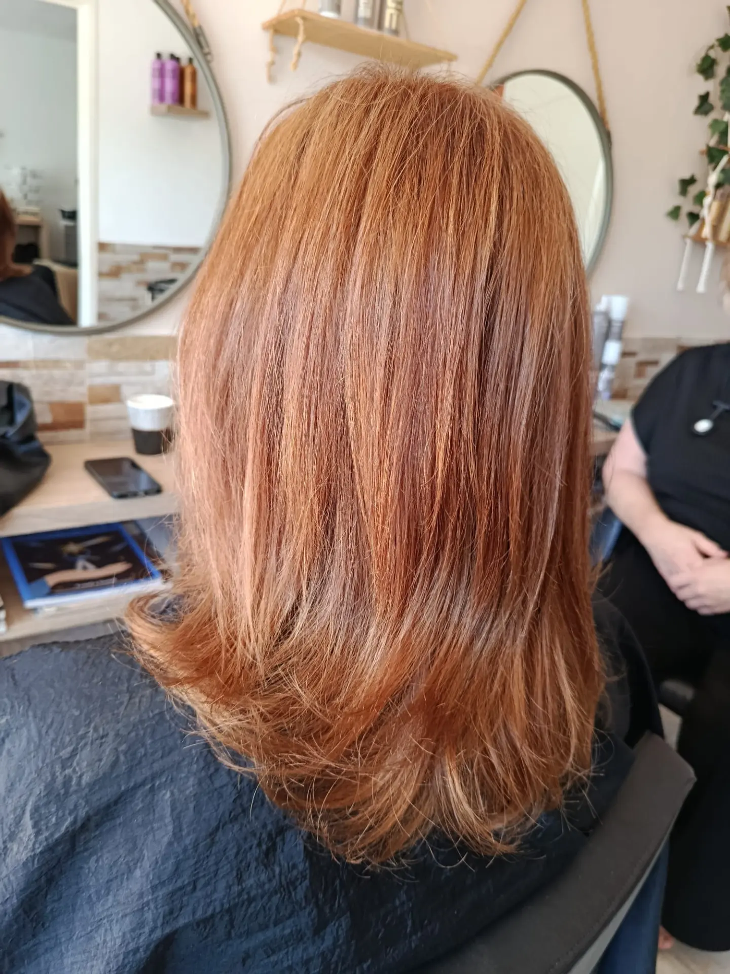 Mid-length strawberry copper hair with a soft bouncy finish