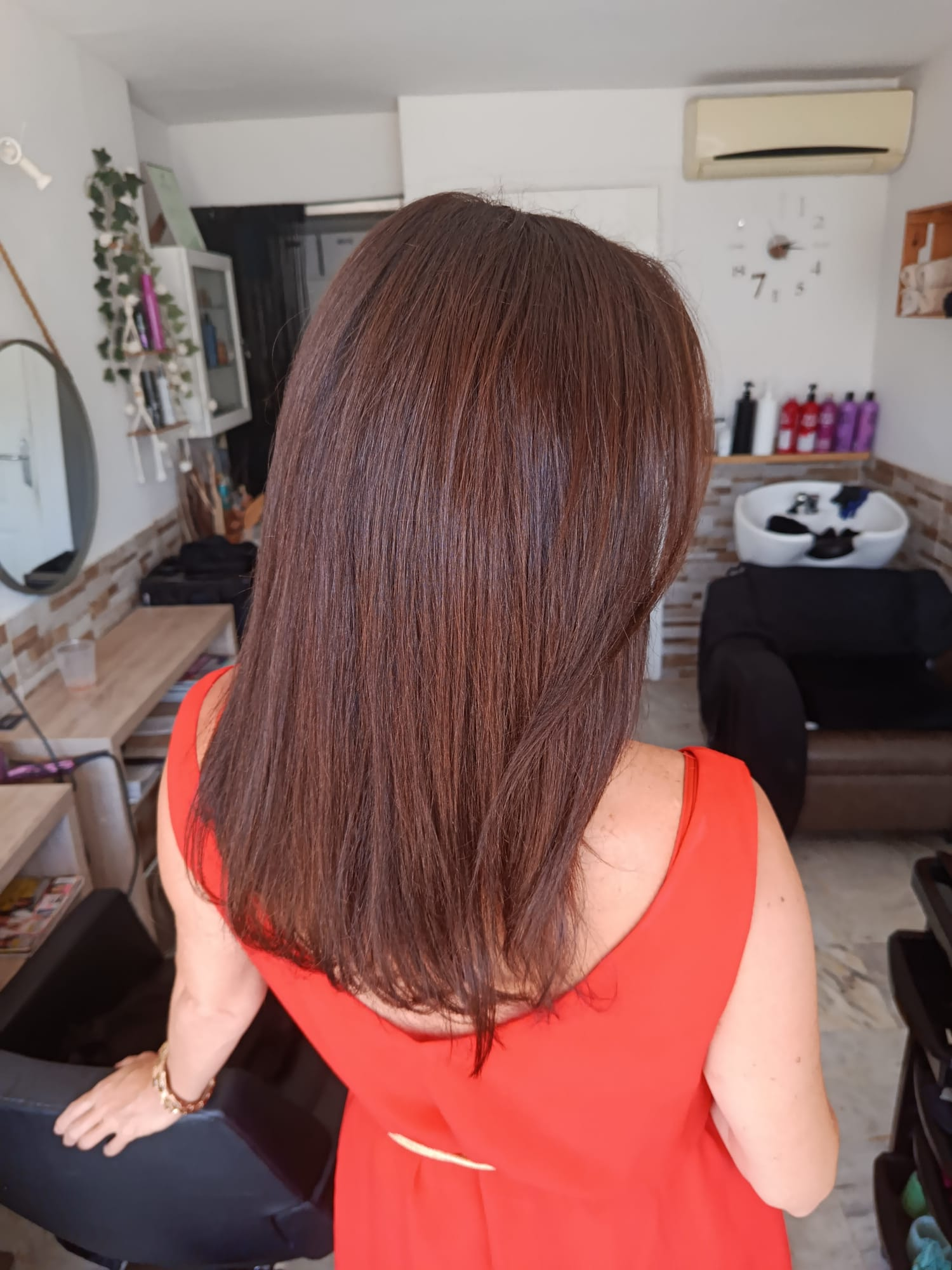 Glossy rich brunette shoulder-length hair after a colour service