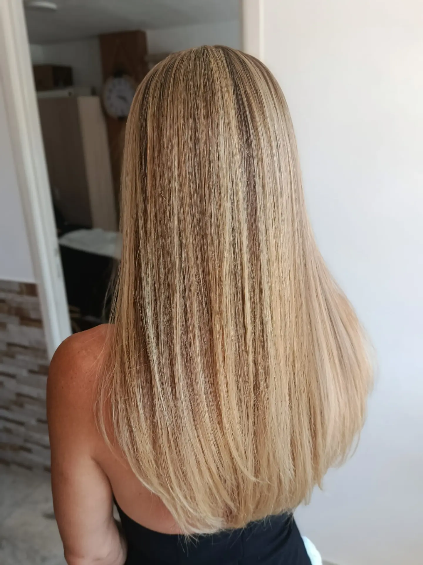 Long golden blonde hair with dimensional highlights and added length