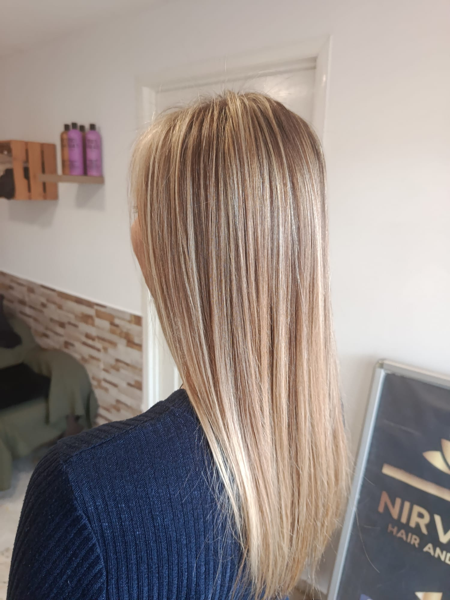 Fine blonde highlights through long straight hair
