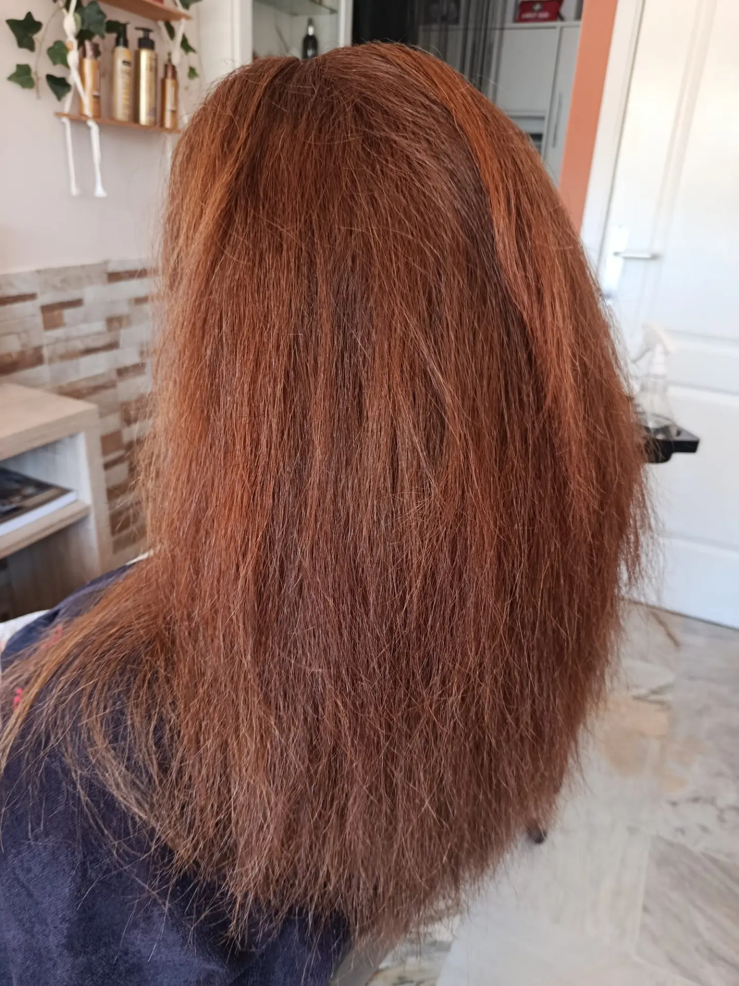Frizzy copper red hair before a keratin smoothing treatment