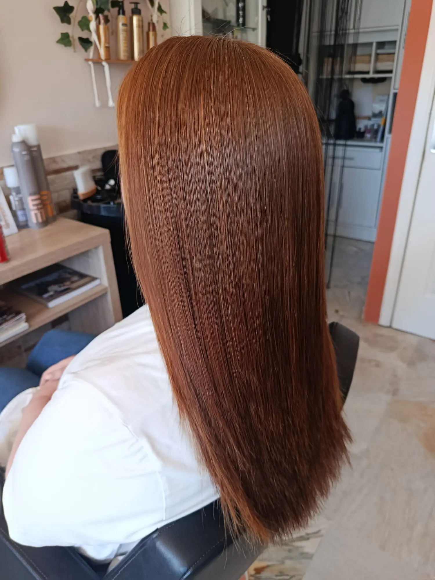 Glossy smooth copper red hair after a keratin treatment