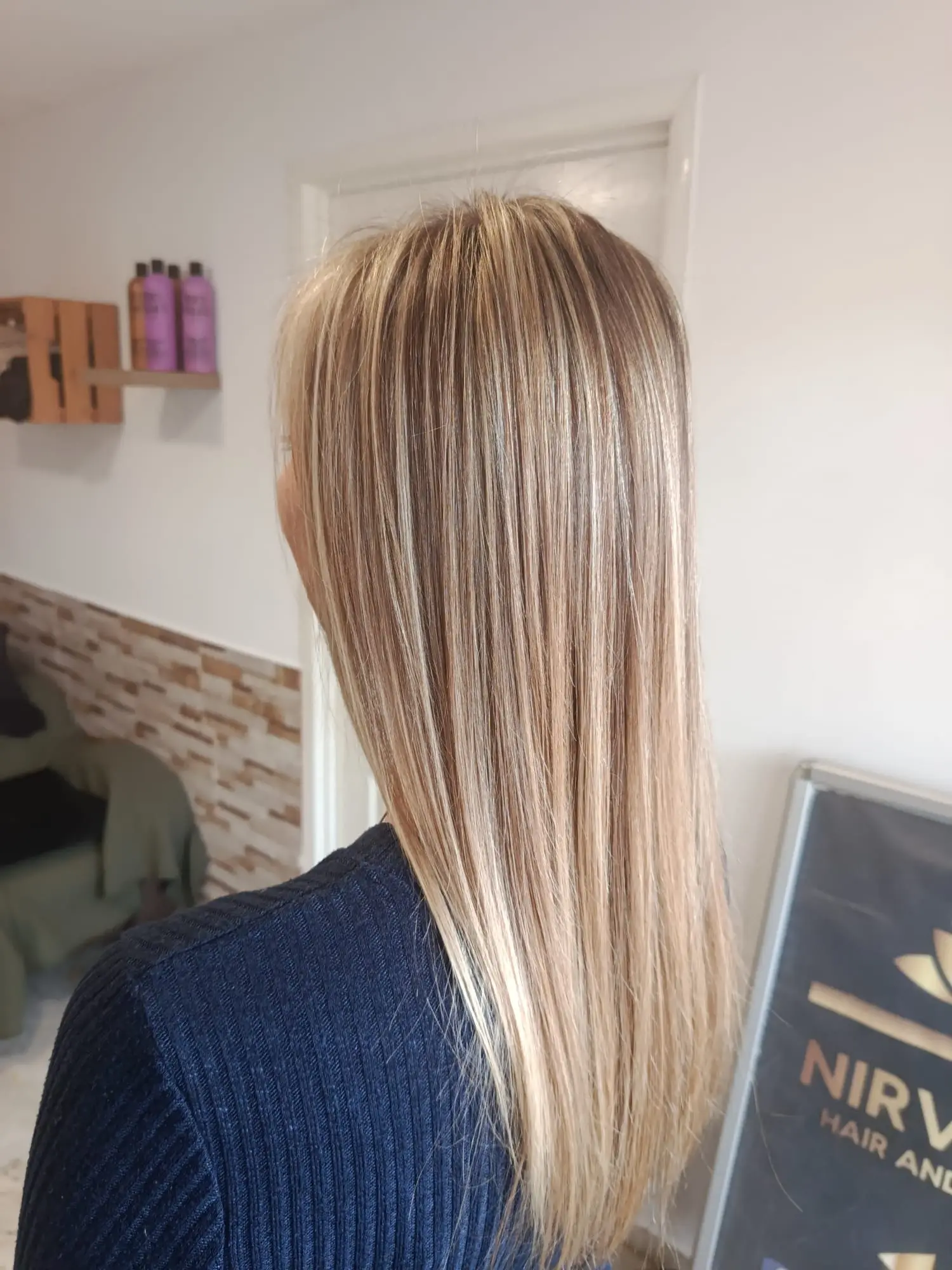 Fine blonde extensions blended through long straight hair