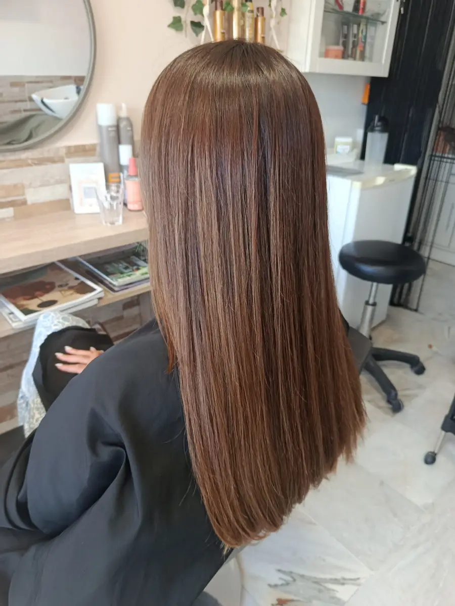 Sleek straight chocolate brown hair with an all-over colour